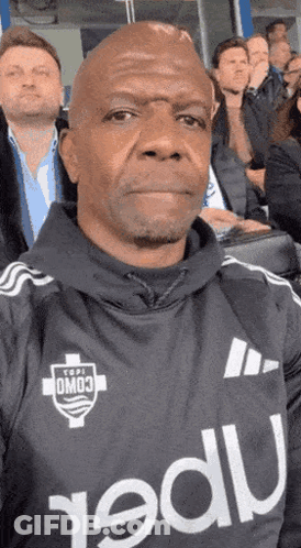 Man In Omo3 Jersey Taking Selfie In Stadium GIF