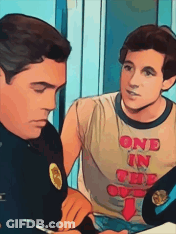 Man In One In The Oval T-Shirt Talks To Another Man GIF