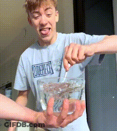 Man In One Piece Shirt Holding Bowl Of Water GIF