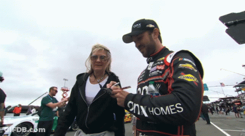 Man In ONX Homes Jacket Signing Woman's Hand GIF