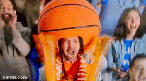 Man In Orange Basketball Costume Holding Trophy GIF