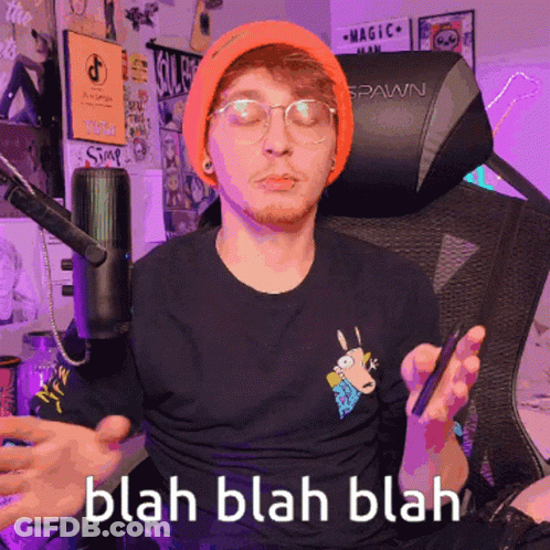 Man In Orange Beanie And Glasses Sitting In Spawn Chair GIF