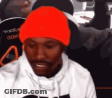 Man In Orange Beanie Sitting GIF