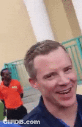 Man In Orange Boss Shirt Smiling GIF