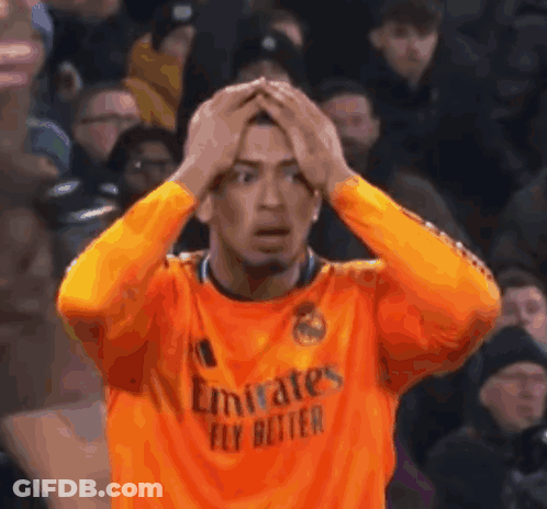 Man In Orange Emirates Fly Better Jersey Holding Head GIF