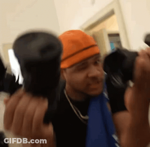 Man In Orange Hard Hat Holding Two Flashlights GIF