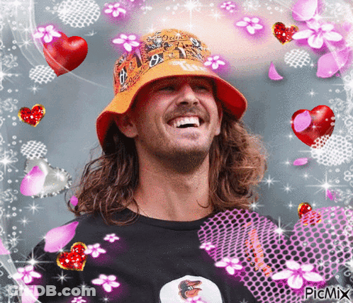 Man In Orange Hat Surrounded By Flowers And Hearts GIF
