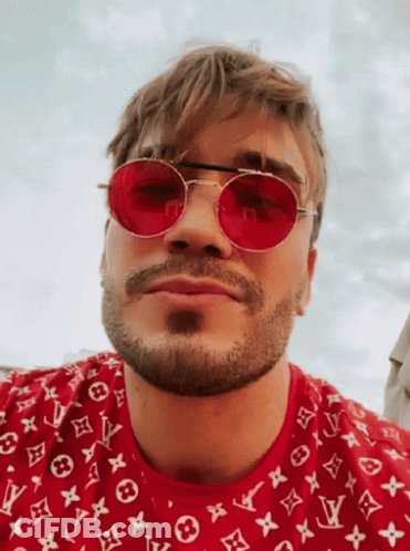 Man In Orange Hoodie And Black 101 Des Shirt At Microphone GIF