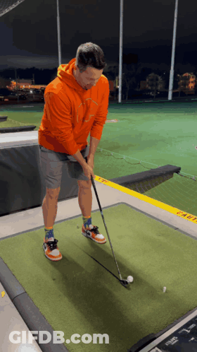 Man In Orange Hoodie Playing Golf GIF