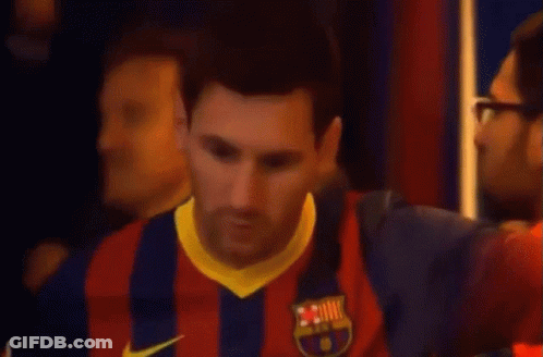 Man In Orange Jacket Helping Man In Qatar Shirt GIF