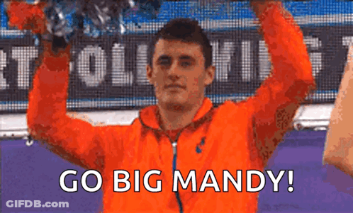 Man In Orange Jacket Holding Trophy Saying Go Big Mandy GIF