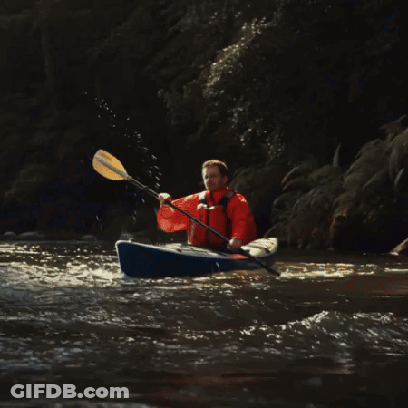 Man In Orange Jacket Paddling Blue Kayak GIF