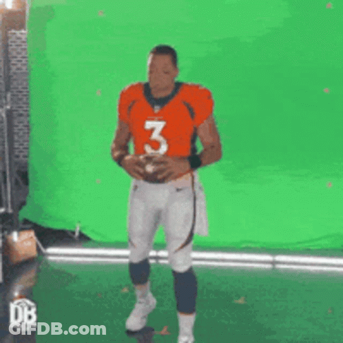 Man In Orange Jersey Number 3 Holding Football GIF