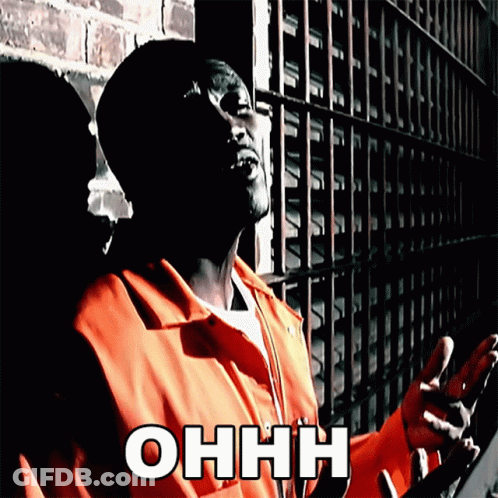 Man In Orange Jumpsuit At Brick Wall With Ohhh GIF