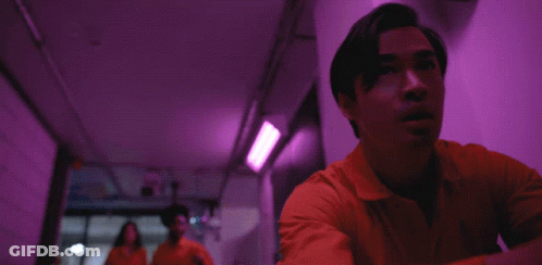 Man In Orange Jumpsuit Running Down Hallway GIF