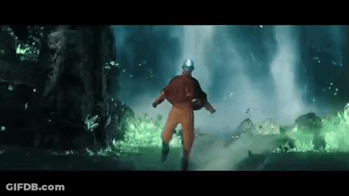 Man In Orange Jumpsuit Running In Front Of Waterfall GIF