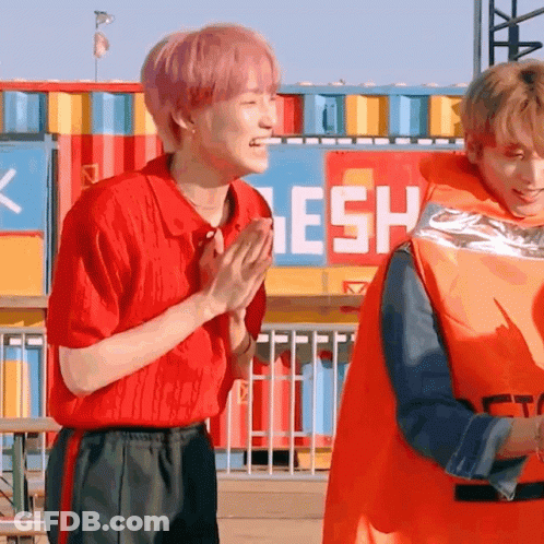 Man In Orange Life Vest Standing Next To Another Man GIF