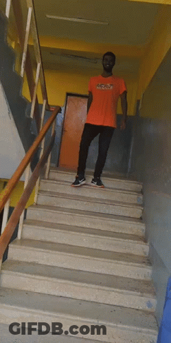 Man In Orange NC State T-Shirt On Stairs GIF
