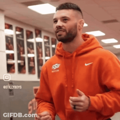 Man In Orange Nike Hoodie Standing In Gym GIF