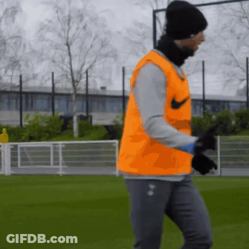 Man In Orange Nike Vest On Field GIF