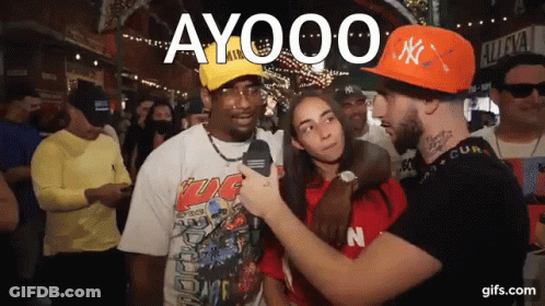 Man In Orange NY Hat Talking To Woman GIF
