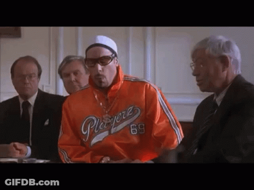 Man In Orange Playerz 69 Jacket At Table With Men GIF
