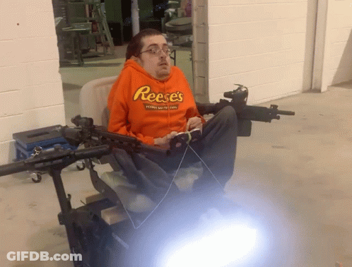 Man In Orange Reese's Hoodie Sitting GIF