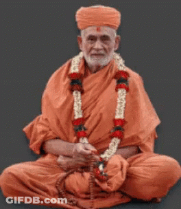 Man In Orange Robe Holding Globe And Candle GIF