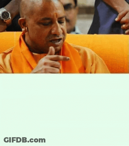 Man In Orange Scarf And Watch Sitting On Couch GIF