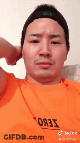 Man In Orange Shirt And Black Hat GIF