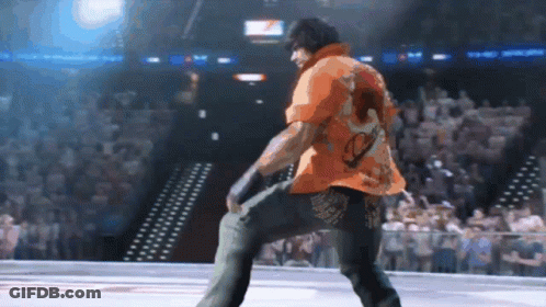 Man In Orange Shirt Dancing In Stadium GIF