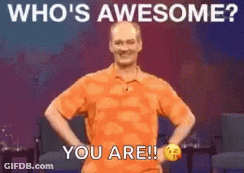 Man In Orange Shirt Hands On Hips Saying Whos Awesome You Are GIF