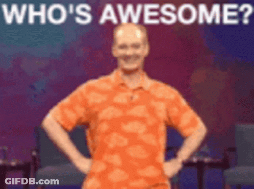 Man In Orange Shirt Hands On Hips Says Who's Awesome GIF