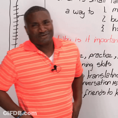 Man In Orange Shirt In Front Of A Way To Whiteboard GIF