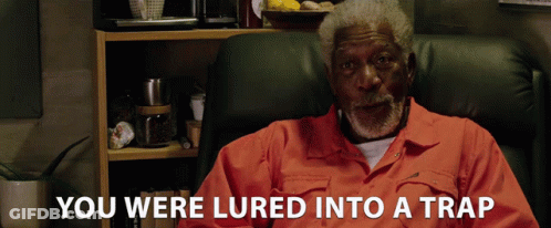 Man In Orange Shirt Lured Into A Trap GIF