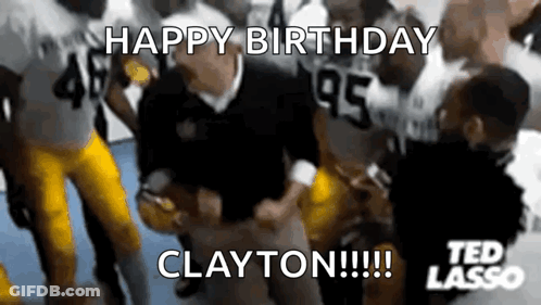 Man In Orange Shirt Making Funny Face In Front Of Trophies GIF