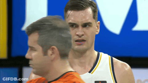Man In Orange Shirt Next To Basketball Player GIF