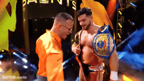 Man In Orange Shirt Next To Wrestler GIF