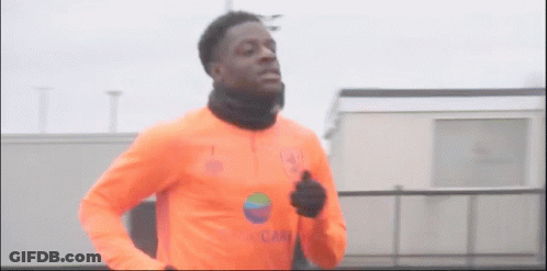 Man In Orange Shirt Running GIF