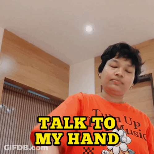 Man In Orange Shirt Saying Talk To My Hand GIF