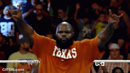 Man In Orange Shirt Saying Texas Peace Sign GIF