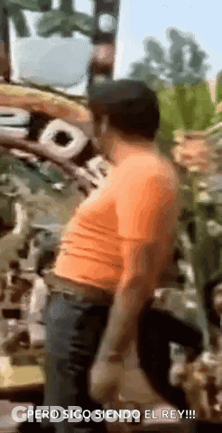 Man In Orange Shirt Says Pero Sigo Siendo El Rey GIF