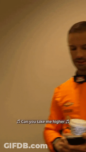 Man In Orange Shirt Singing Can You Take Me Higher GIF