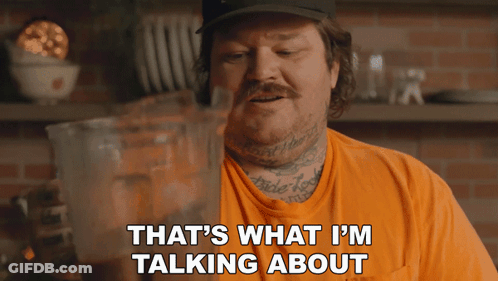 Man In Orange Shirt Talking GIF