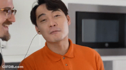 Man In Orange Shirt Wearing Headphones GIF