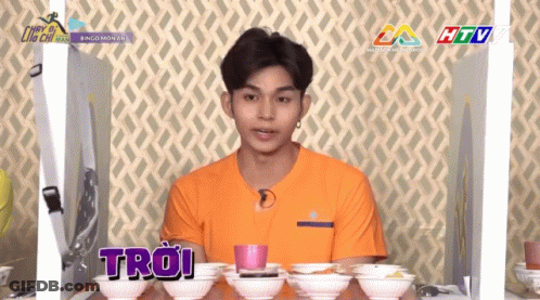 Man In Orange Shirt With Troi Bowls GIF