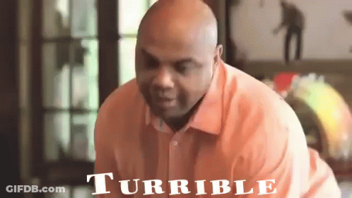 Man In Orange Shirt With Turrible Sign GIF