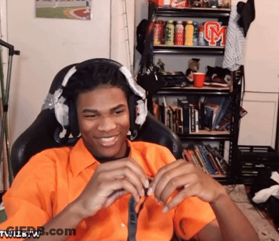 Man In Orange Shirt With Twizbtw Sticker GIF