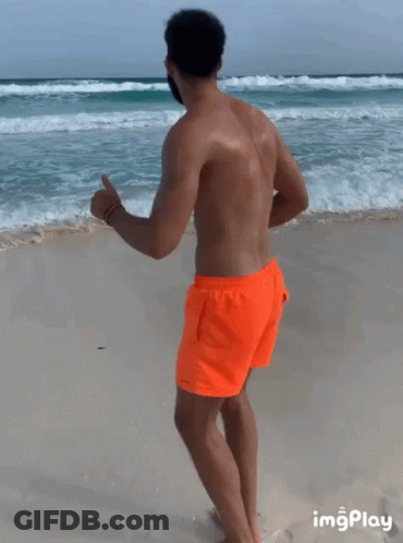 Man In Orange Shorts Running Beach GIF