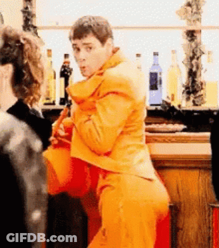 Man In Orange Suit At Bar GIF